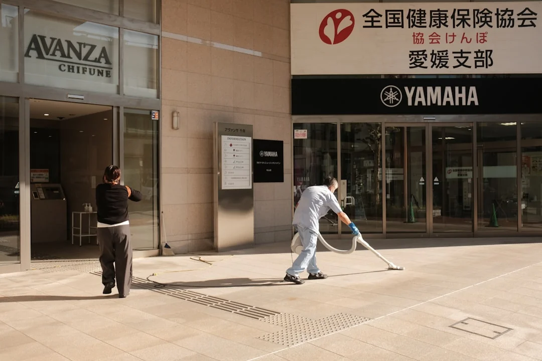 our-story A couple packing labeled boxes in a minimalist living room, preparing for moving day.